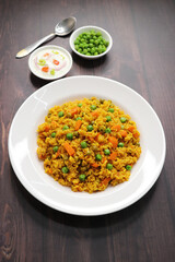 Carrots and Peas Pilaf or Gajar Matar Pulao. It is a one pot rice dish made with Basmati Rice and Vegetables, seasoned with spices, Served with yogurt raita or curd. Healthy weight loss meal. copy