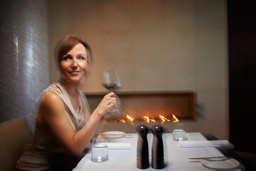 Woman, motion blur and restaurant for dinner, table or wine glass for celebration. Alcohol,...