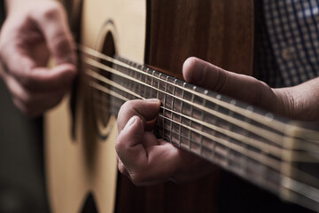 Hands, home and man with guitar, talent and instrument with strings, performance and musician....