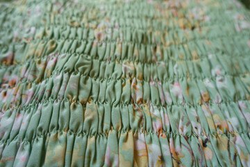 Close view of light mint green rayon fabric with shirring