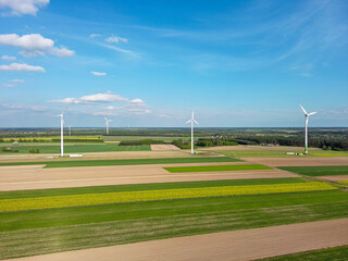 Spring farmlands and electric windmills.