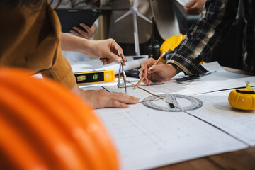 Engineer teams meeting working together wear worker helmets hardhat on construction site in modern...