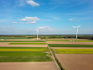 Spring farmlands and electric windmills.