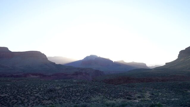 rays shine in an early morning grand canyon