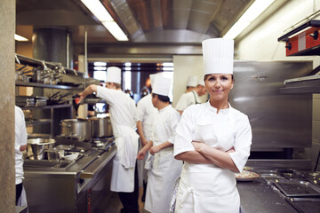 Restaurant, chef and portrait of woman with arms crossed for culinary service, job and pride in kitchen. Fine dining, person and face of cook in food industry for catering, career and hospitality - Powered by Adobe