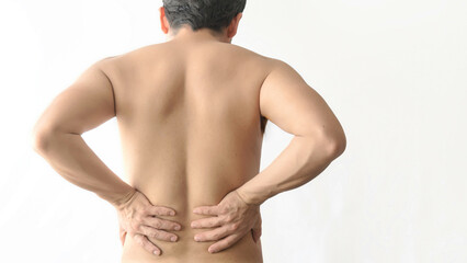 Kidney pain. Holding lower back with hands. Man with back pain. Shirtless body. Man body pain on a...