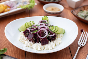red beetroot vegetable salad on a white plate on the table serving