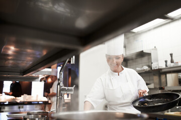 Cooking, chef and happy woman in kitchen at restaurant for fine dining, service and hospitality....
