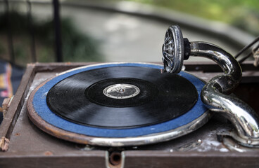 Old turntable. retro historical fashioned record player. Vinyl record spinning on a pathephone.