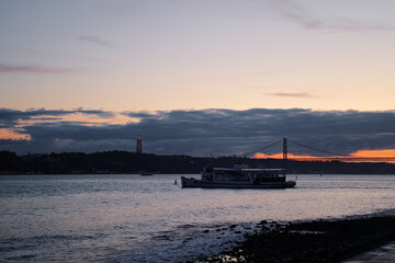 Sunset on Tagus river in Lisbon. View on the Bridge