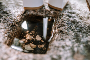 Valmiera, Latvia - August 19, 2023 - Close-up of a diamond engagement ring near a small puddle in a...