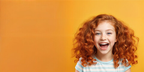 Cute young child  Little girl smiles. Emotion and child development. Little girl smiles while red hair.  A young girl with curly hair is smiling and laughing while wearing a shirt.