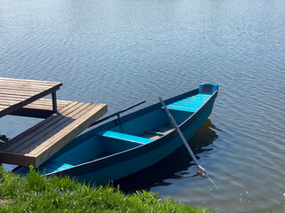 Naklejka na ściany i meble Wooden boat on the lake