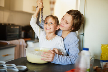 Kitchen, mother and daughter with dough or spoon in home for learning, baking and bonding together....
