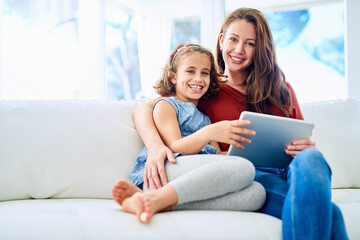 Family, portrait of mother and daughter with tablet on sofa in living room of home for education or...