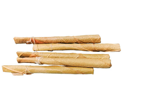 Bidi or Beedi, A beedi is a thin cigarette or mini-cigar filled with tobacco flake and commonly wrapped in a tendu or Piliostigma racemosum leaf tied with a string or adhesive, bidi isolated 