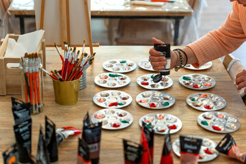 Painting workshop. Painting teacher preparing the colors.