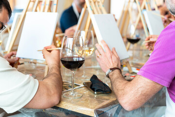 Painting workshop. Students painting with a glass of wine