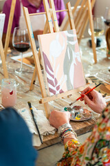 Painting and sip workshop. Woman enjoying art and wine.