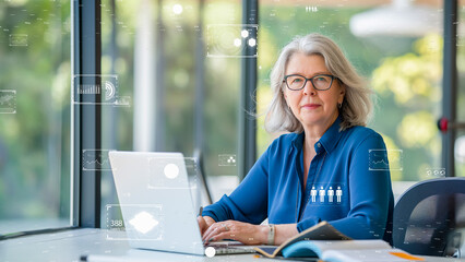 A senior woman executive multitasking with digital tools, exemplifying efficiency and technology in business