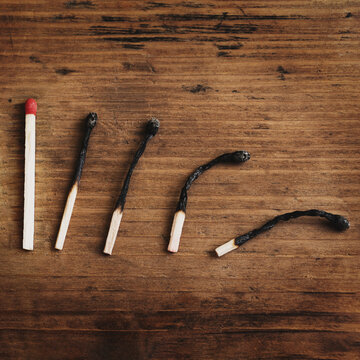 Conceptual Image of Burnt Matches on Wooden Background