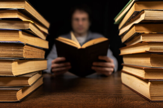 Man holding Open book in hands. Male hands hold a hardcover book. Education, literature, knowledge, reading concept