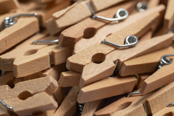 heap wooden clothespins close up. background