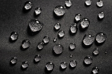 Close-up view on water drops on waterproof impregnated fabric in rain