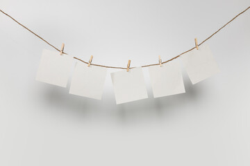 5 clean sheets on clothesline with clothespins isolated on white background - obrazy, fototapety, plakaty