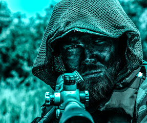 A camouflaged soldier with a piercing gaze, in tactical gear, keeps watch, in the jungle forest swamp. Close up portrait with rifle. 