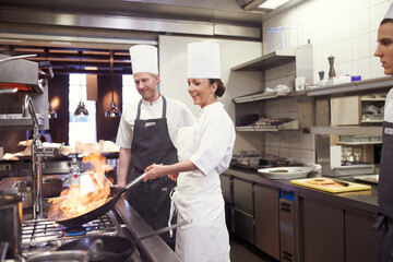 Restaurant, chef and pan with flame in kitchen for cooking, culinary career and hospitality...