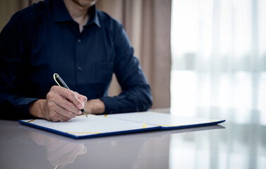 businessman signing document and hand holding pen putting signature at paper,Signing a form,sign...