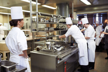 Chef, staff and cooking professional in kitchen for evaluation of culinary education, training and performance management. Woman, students and supervision for feedback or guidance and learning skill.