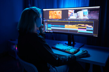 Beautiful Female Video Editor Works with Footage on Her Personal Computer, She Works in Creative...