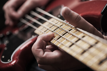 Hands, person and guitar strings to practice for performance or concert, show and entertainment....