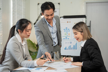 Asian businessmen, women and men Talk about new projects, presents at home office.
