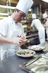 Asian man, chef and plate with food in kitchen for restaurant, service and hospitality in Bangkok....