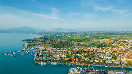 Overlooking the picturesque town of Peschiera del Garda, nestled by the tranquil waters of Lake...