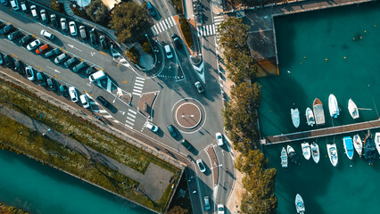 Overhead view capturing Peschiera del Garda vibrant streets and docks beside the tranquil waters of...