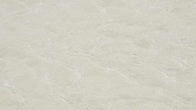 Running Water Sea on Beige Sand Becah Background, Shore Isalnd at Coast Nature Summer Tropical for Tourism Vacation Relax Travel Holidays.