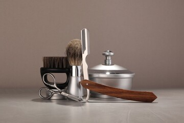 Moustache and beard styling tools on grey table