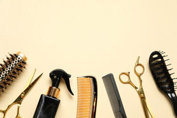 Different hairdresser tools on beige background, flat lay. Space for text