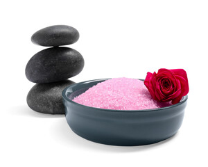 Obraz na płótnie Canvas Pink sea salt in bowl, rose and spa stones isolated on white
