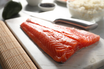 Fresh salmon for sushi on table, closeup