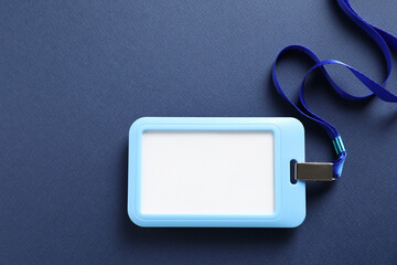 Blank badge with string on blue background, top view