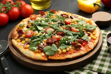 Delicious vegetarian pizza, ingredients and cutter on black table, closeup