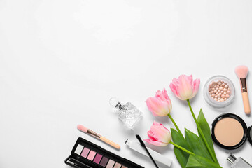 Flat lay composition with different makeup products and beautiful spring flowers on white...