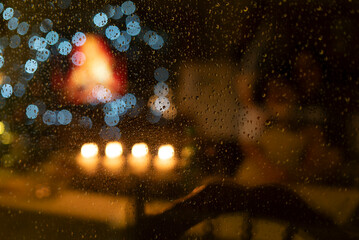 Blurred background of water drops on the window glass with bokeh