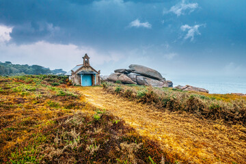 small chapel on the coast of french brittany. Chapel of St. Guirec between rocks, Sentier des...