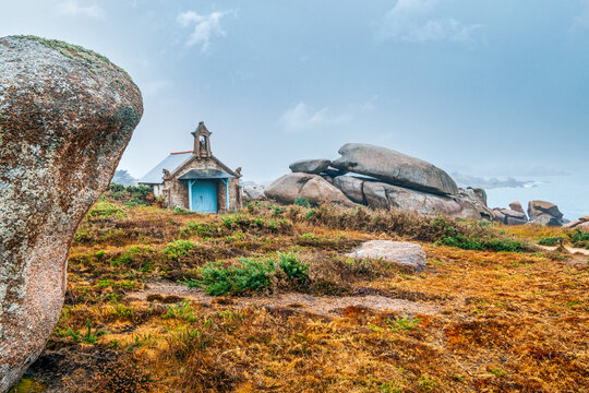 small chapel on the coast of french brittany. The Devil's chapel on the Pink Granite Coast in northern Brittany, France, with its granite chimeras is in fact a boathouse.